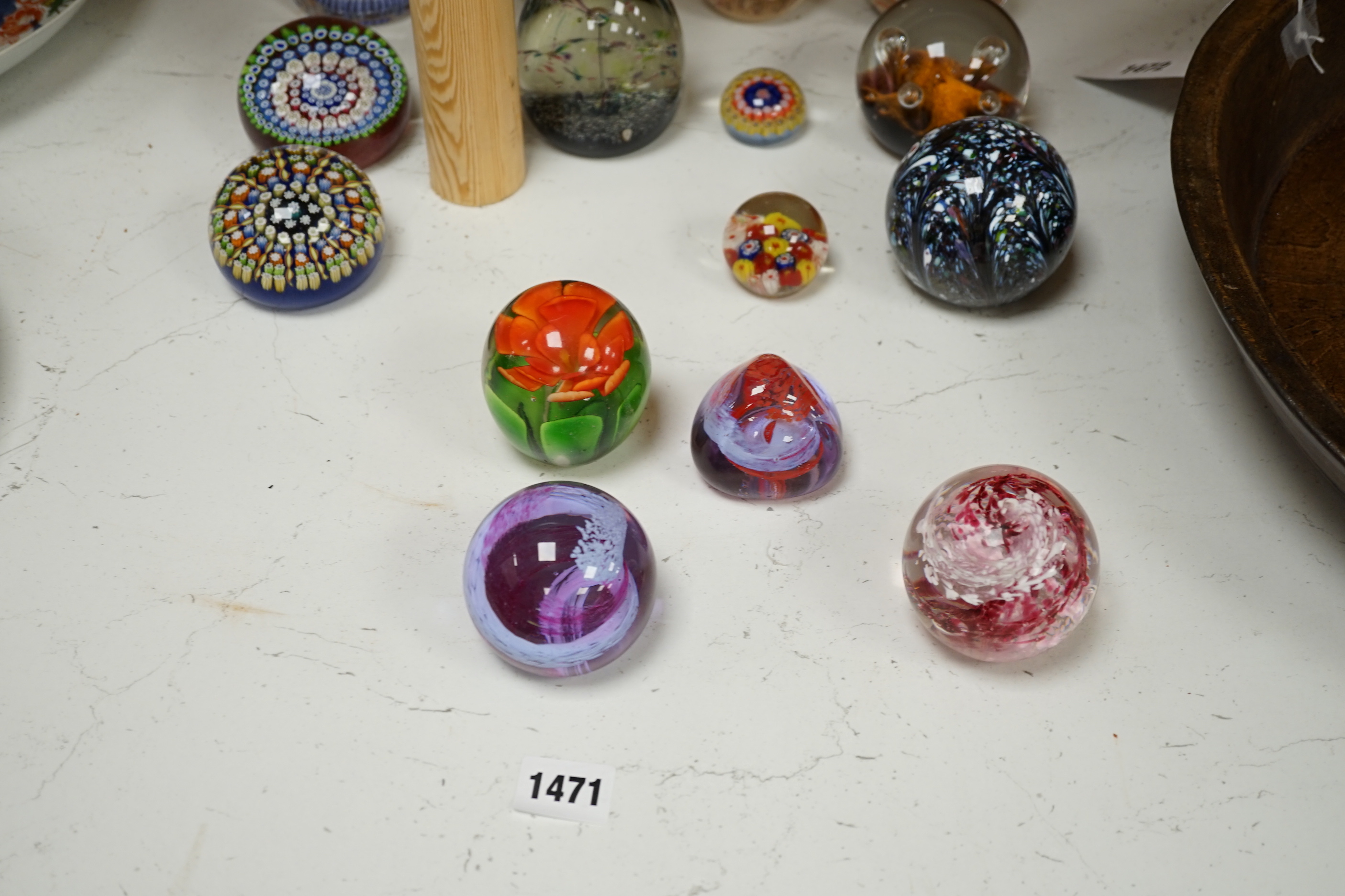 A collection of nineteen glass paperweights; mostly Caithness with two being Whitefriars and another Perthshire